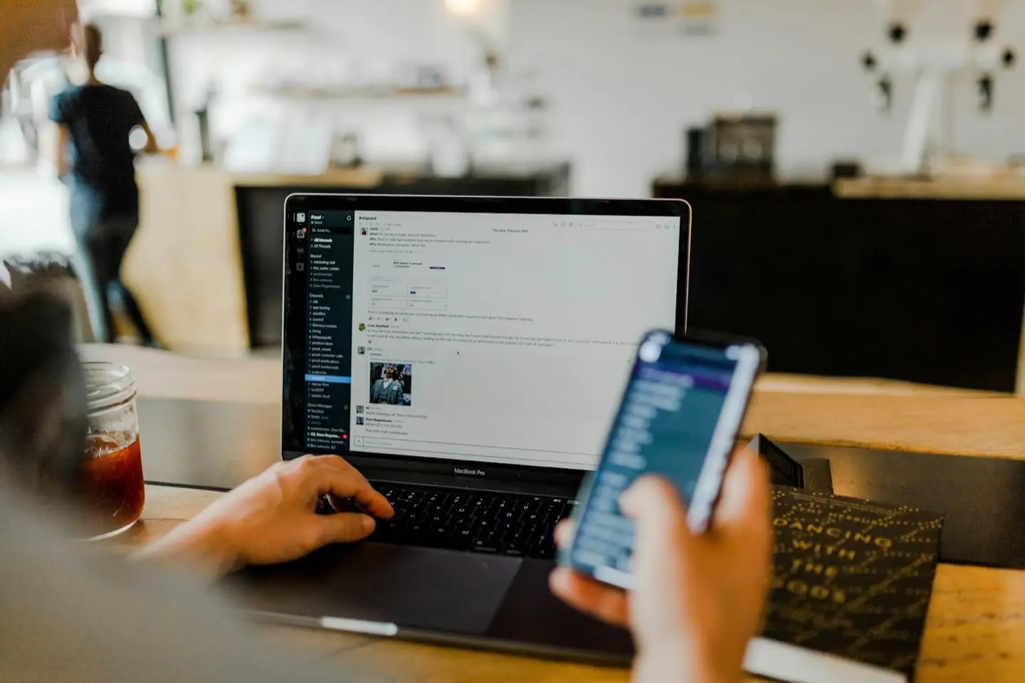 Notebook und Smartphone mit Auswertungen auf dem Schreibtisch